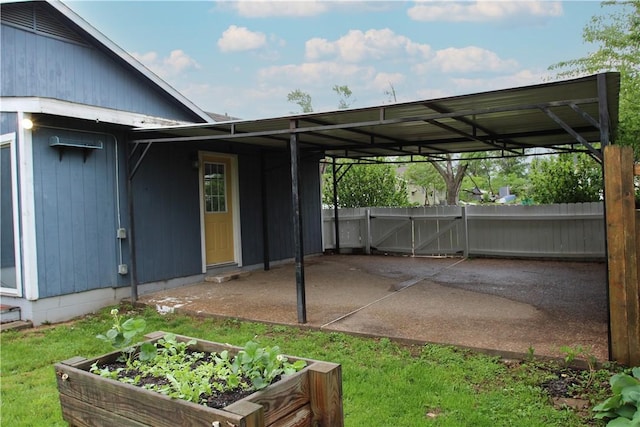 exterior space with fence and a vegetable garden
