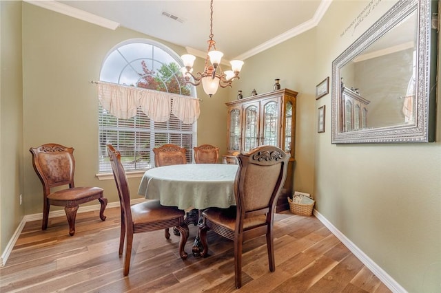 dining space featuring plenty of natural light, ornamental molding, a chandelier, and visible vents