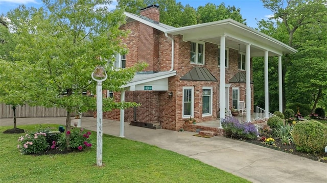 1100 N Lowell Rd, Springdale, AR 72784 - view of front of house featuring brick siding, a front lawn, fence, and a chimney