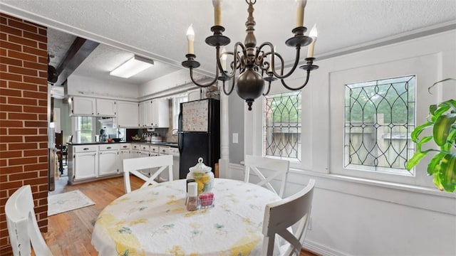 1100 N Lowell Rd, Springdale, AR 72784 - dining space with light wood-style floors, a textured ceiling, and a chandelier
