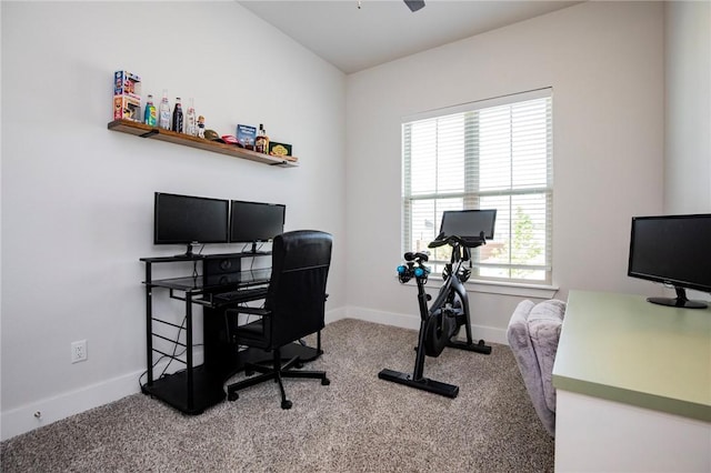 carpeted office space with baseboards and a ceiling fan