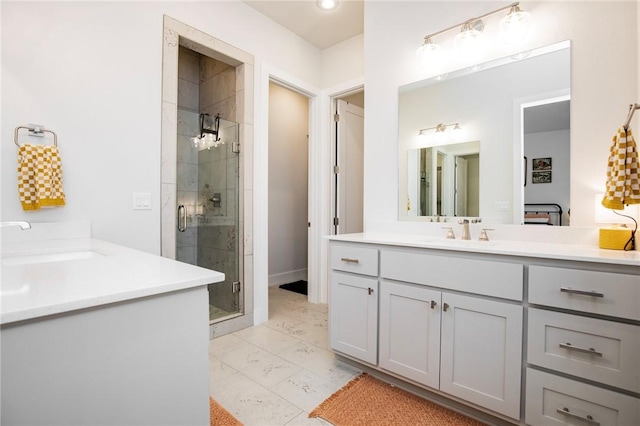 full bathroom with two vanities, a sink, marble finish floor, and a stall shower