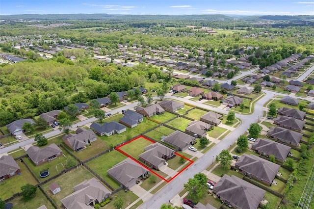 drone / aerial view with a residential view and a wooded view