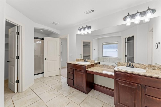 full bathroom with visible vents, tile patterned floors, vanity, and a shower stall