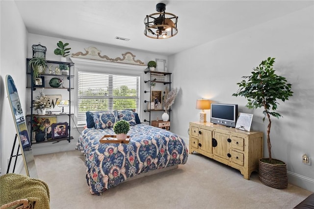 bedroom featuring visible vents and light carpet