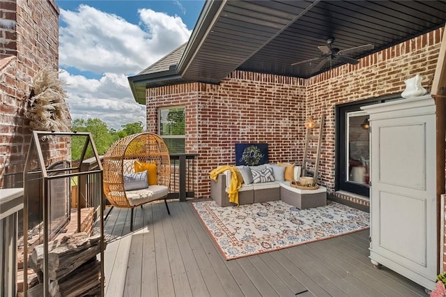 deck with an outdoor living space and a ceiling fan