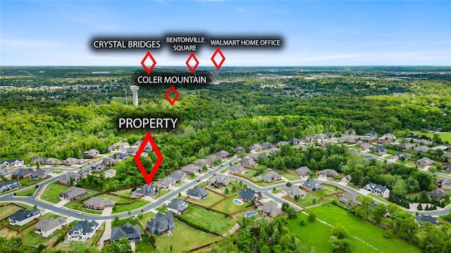 drone / aerial view featuring a residential view and a forest view