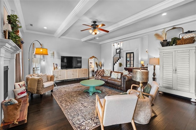 living area with stairway, ceiling fan, beamed ceiling, and dark wood-style floors