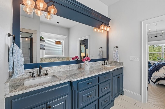 ensuite bathroom with tile patterned floors, a sink, ensuite bathroom, and a stall shower
