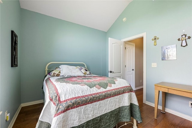 bedroom with baseboards, wood finished floors, and lofted ceiling