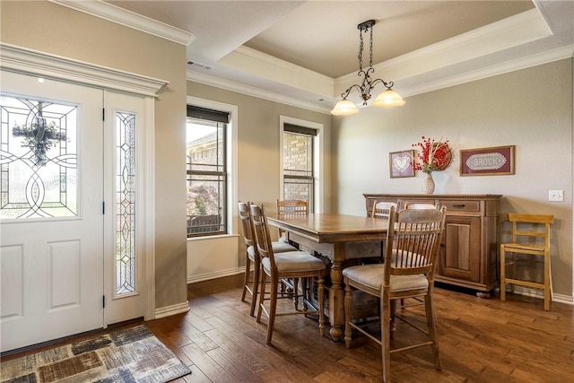 dining area featuring baseboards, dark wood finished floors, ornamental molding, and visible vents