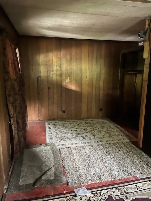 spare room with wooden walls