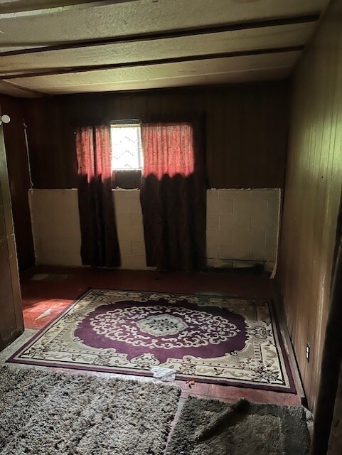 empty room featuring wood walls
