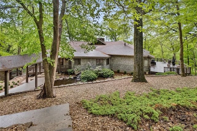 10 Spring Valley Dr, Bentonville, AR 72712 - view of side of property featuring roof with shingles, a wooden deck, and stone siding