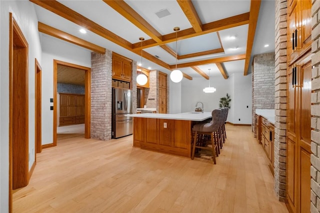 10 Spring Valley Dr, Bentonville, AR 72712 - kitchen featuring beamed ceiling, baseboards, light countertops, brown cabinets, and stainless steel fridge with ice dispenser