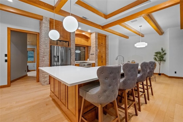10 Spring Valley Dr, Bentonville, AR 72712 - kitchen featuring stainless steel fridge, baseboards, beamed ceiling, and visible vents
