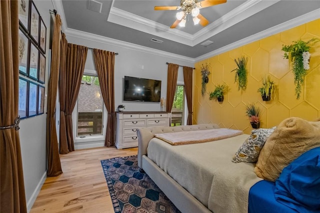10 Spring Valley Dr, Bentonville, AR 72712 - bedroom featuring light wood-style floors, a tray ceiling, visible vents, and multiple windows