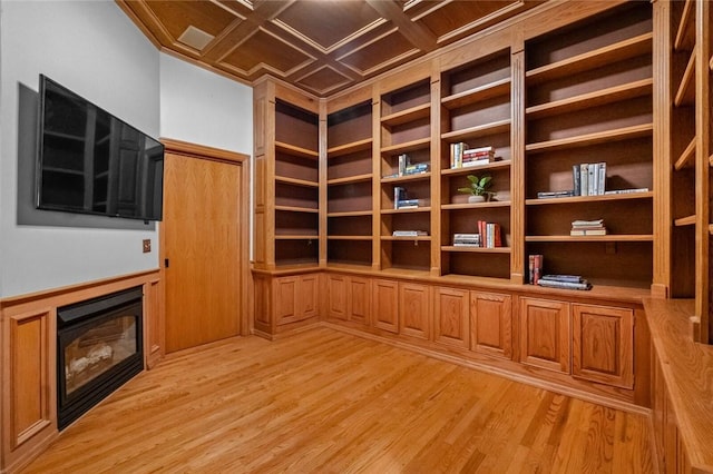 10 Spring Valley Dr, Bentonville, AR 72712 - interior space featuring a glass covered fireplace, wainscoting, and light wood finished floors