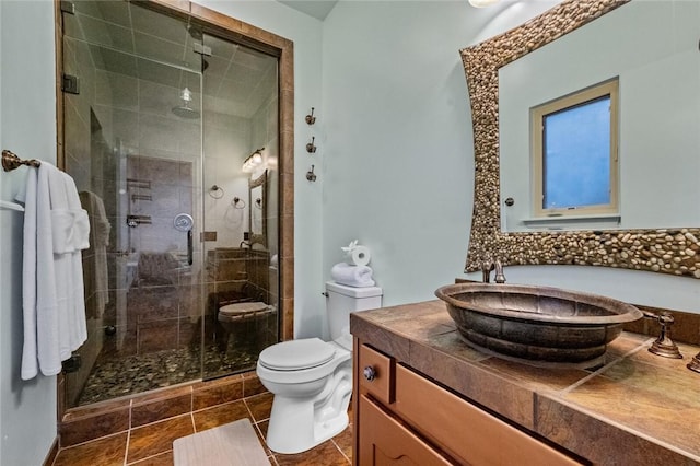 10 Spring Valley Dr, Bentonville, AR 72712 - bathroom featuring toilet, a stall shower, tile patterned floors, and vanity