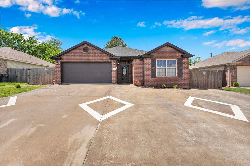 1300 N 31st St, Rogers, AR 72756 - ranch-style house featuring a gate, fence, brick siding, concrete driveway, and a garage