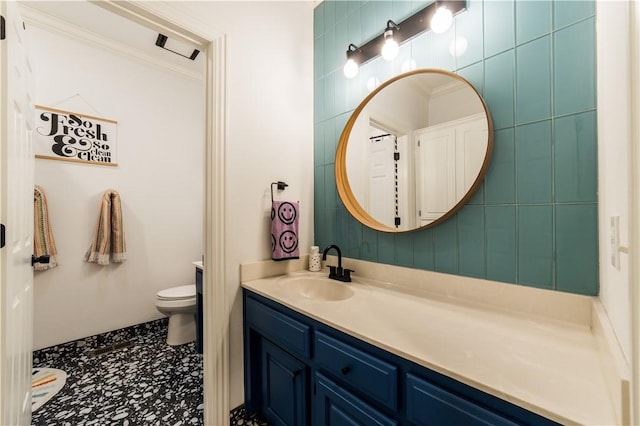 bathroom with vanity, toilet, and crown molding