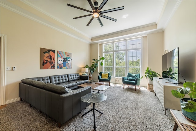 living room featuring ceiling fan, crown molding, carpet floors, and baseboards