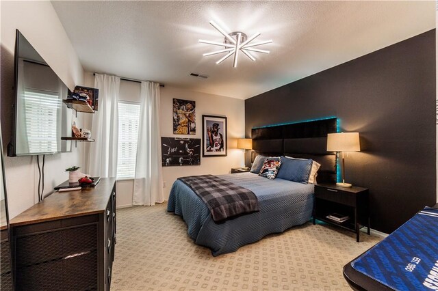 bedroom with light colored carpet and baseboards