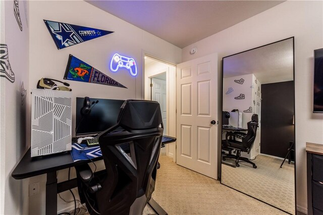 carpeted office featuring baseboards