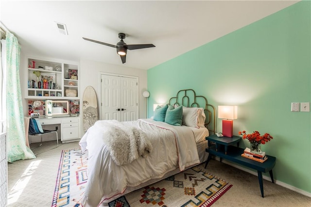 bedroom featuring light carpet, a closet, and ceiling fan