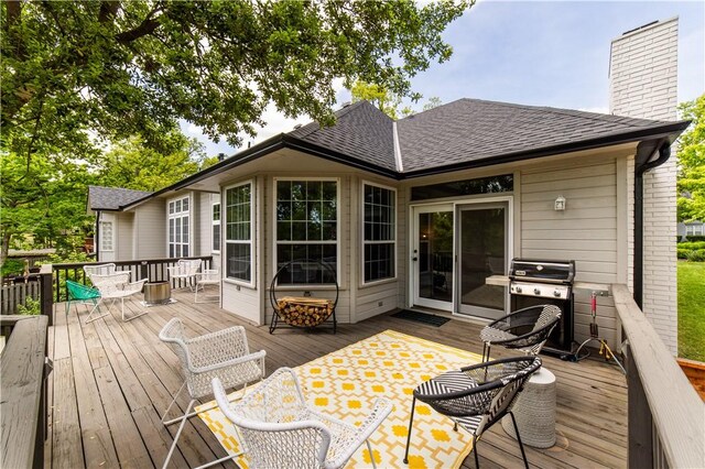 wooden deck featuring grilling area and outdoor dining area