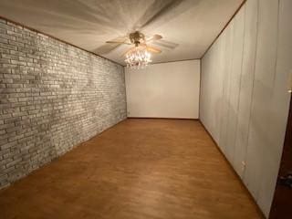 6 Briarwood Ln, Clarksville, AR 72830 - empty room featuring brick wall, light wood-style flooring, and ceiling fan