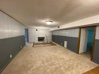 6 Briarwood Ln, Clarksville, AR 72830 - unfurnished living room featuring a large fireplace and a textured ceiling