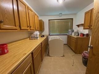 6 Briarwood Ln, Clarksville, AR 72830 - kitchen featuring brown cabinetry, light tile patterned flooring, and light countertops
