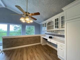 6 Briarwood Ln, Clarksville, AR 72830 - kitchen with vaulted ceiling, ceiling fan, crown molding, wood finished floors, and glass insert cabinets