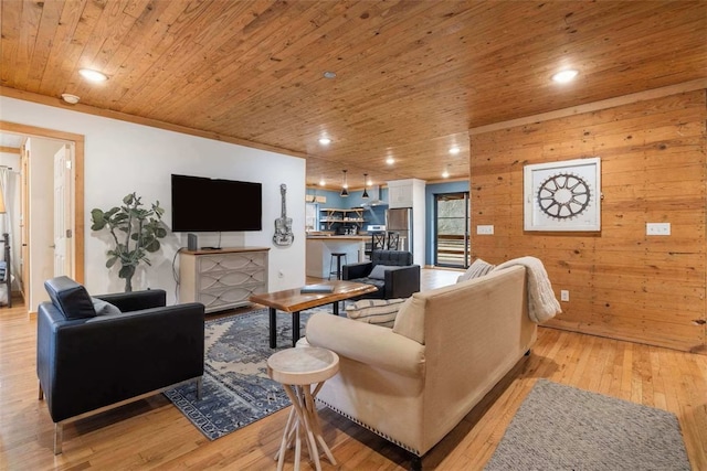 living room with recessed lighting, wood walls, wooden ceiling, and light wood-style flooring