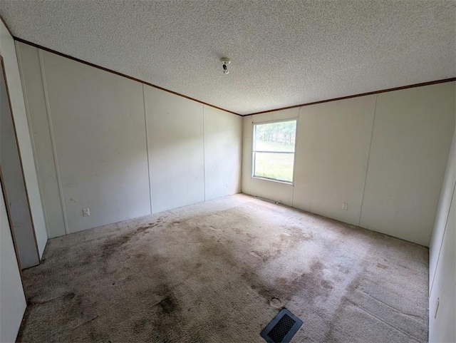 12346 Riggs Ln, Lead Hill, AR 72644 - spare room with ornamental molding, a textured ceiling, and a decorative wall