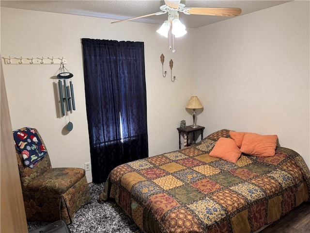 bedroom with ceiling fan and wood finished floors