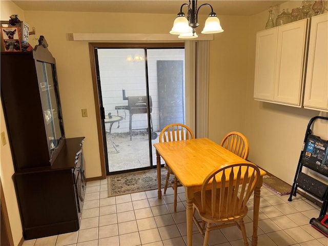 dining area featuring light tile patterned floors and an inviting chandelier