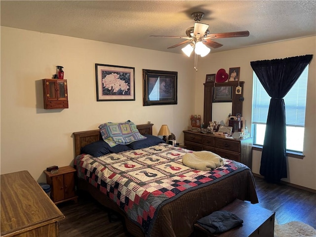 bedroom with a ceiling fan and dark wood-style flooring