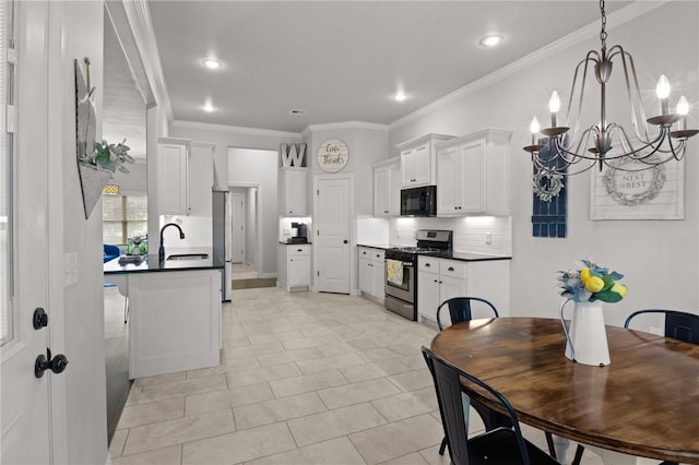 11003 David Ct, Siloam Springs, AR 72761 - kitchen featuring dark countertops, a notable chandelier, black microwave, decorative backsplash, and gas range