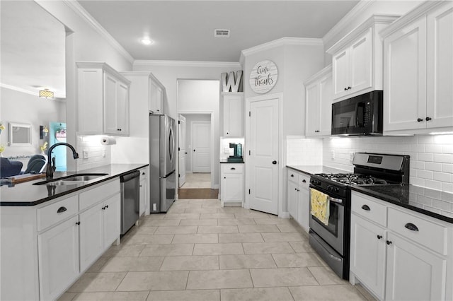 11003 David Ct, Siloam Springs, AR 72761 - kitchen with decorative backsplash, visible vents, appliances with stainless steel finishes, a sink, and white cabinets