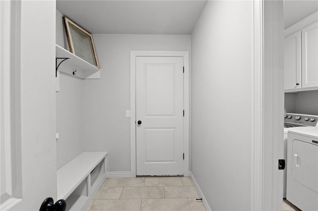 11003 David Ct, Siloam Springs, AR 72761 - clothes washing area featuring cabinet space, baseboards, and light tile patterned floors