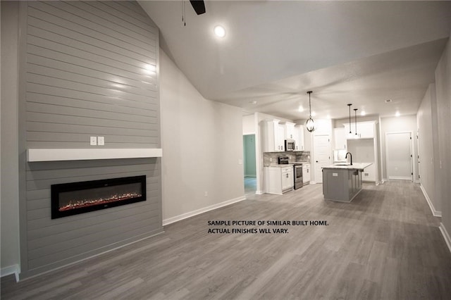 11 Exminster Ln, Bella Vista, AR 72714 - living area featuring baseboards, ceiling fan, and wood finished floors