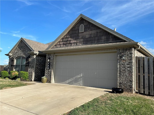 single story home with concrete driveway, a garage, brick siding, and fence