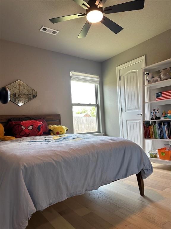 bedroom with wood finished floors and a ceiling fan