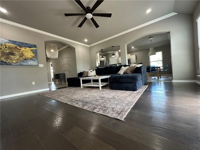 living room featuring arched walkways, ceiling fan, baseboards, dark wood finished floors, and recessed lighting