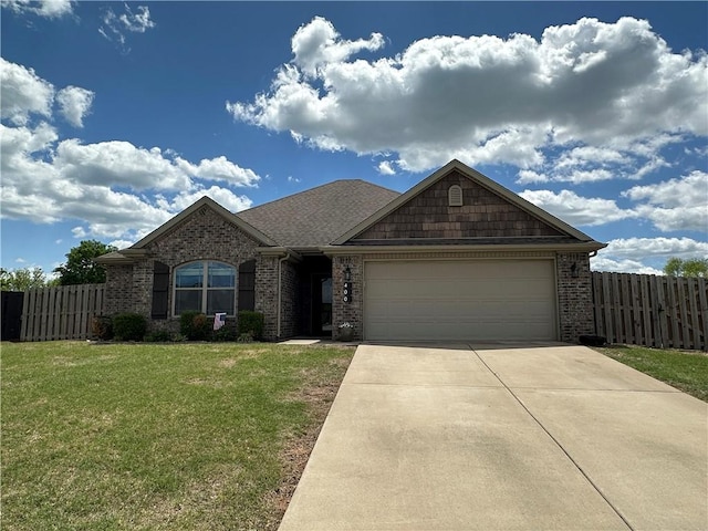 view of front of house featuring an attached garage, driveway, and brick siding