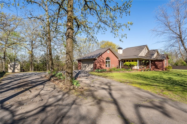 6431 Summer Shade, Van Buren, AR 72956 - exterior space with covered porch, aphalt driveway, a lawn, a storage unit, and an attached garage