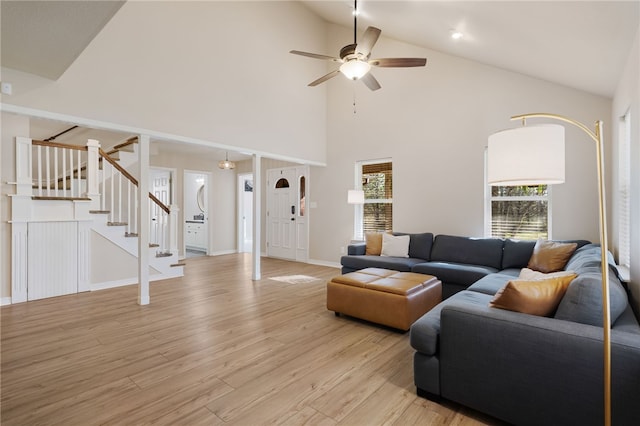 6431 Summer Shade, Van Buren, AR 72956 - living room featuring ceiling fan, high vaulted ceiling, baseboards, light wood-type flooring, and stairway