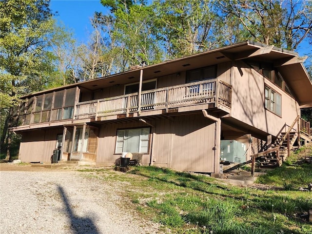 view of front of house featuring stairs and a deck